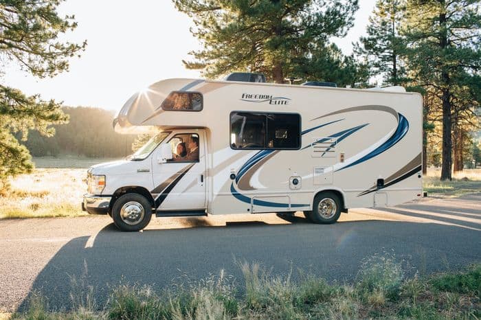 RV driving on the road at sunset to Wurstfest New Braunfels Camping Site Guadalupe River.