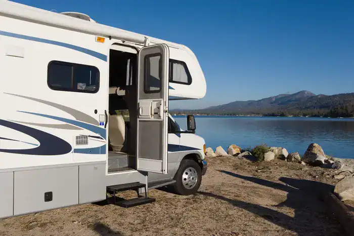 An RV parked by Grand Lake Oklahoma on a sunny day.