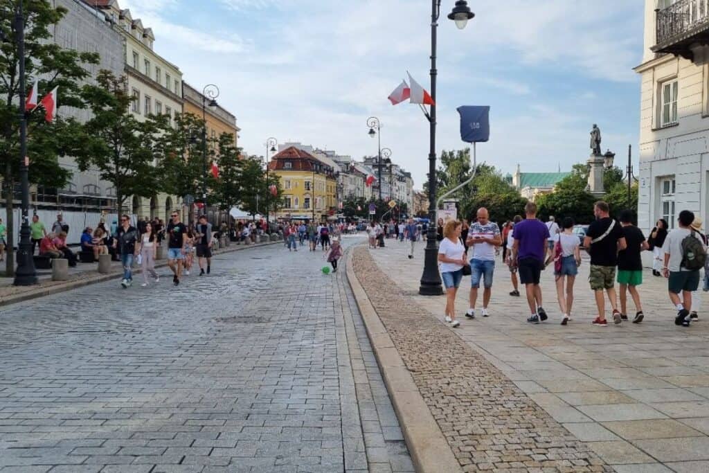 People walking along a wide street in central Warsaw, showing the city is easy to explore with teenagers.