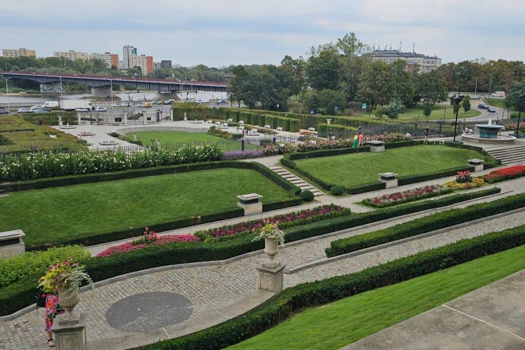 Royal Castle Gardens in Warsaw with formal lawns, flower beds and paths overlooking the city.